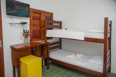 Uma cama ou camas num quarto em Pousada Jerimar