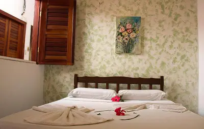 Uma cama ou camas num quarto em Pousada Jerimar