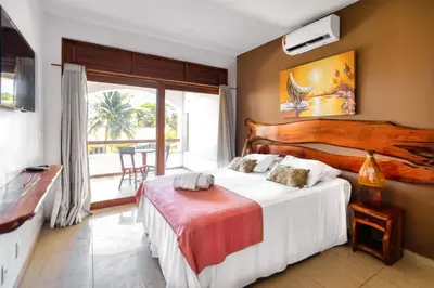 Uma cama ou camas num quarto em Vila Coqueiros Boutique Hotel