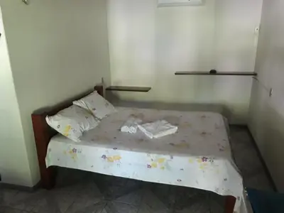 Uma cama ou camas num quarto em Pousada Aconchego