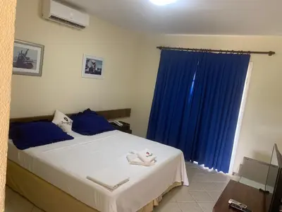 Uma cama ou camas num quarto em Bouganville Hotel