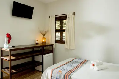 Uma cama ou camas num quarto em Pousada Por do Sol