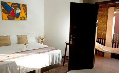 Uma cama ou camas num quarto em Pousada Por do Sol