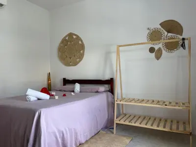 Uma cama ou camas num quarto em Pousada Paracuru Surf