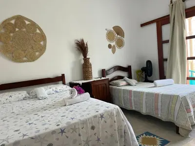 Uma cama ou camas num quarto em Pousada Paracuru Surf