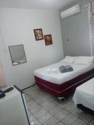 Uma cama ou camas num quarto em Pousada Atlantico Centro - Fortaleza