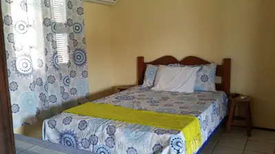 Uma cama ou camas num quarto em Pousada Recanto das Férias