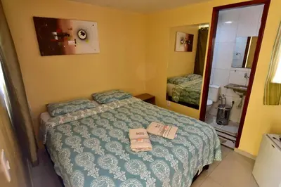 Uma cama ou camas num quarto em Pousada do Turista
