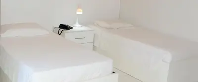 Uma cama ou camas num quarto em Hotel Americas