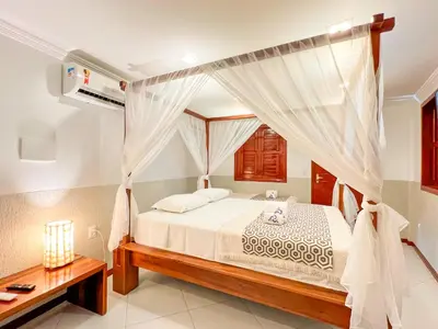 Uma cama ou camas num quarto em Rede Andrade Dunas
