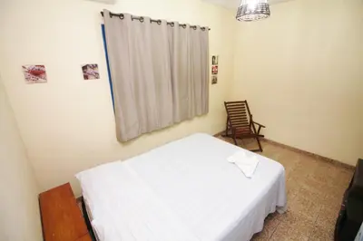 Uma cama ou camas num quarto em Pousada Fortaleza Aeroporto House