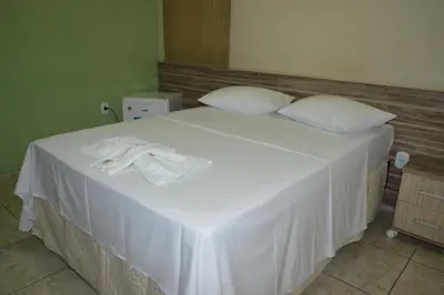 Uma cama ou camas num quarto em Pousada Ayrumã