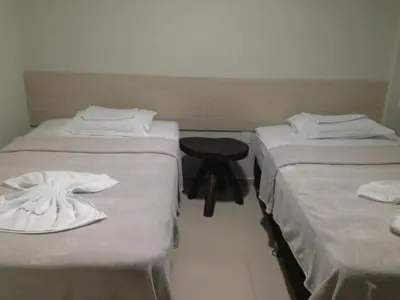 Uma cama ou camas num quarto em Hotel Litoral Fortaleza