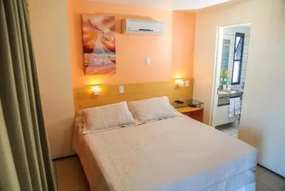 Uma cama ou camas num quarto em Belíssimo Apart com Vista Mar - Conforto a 100m da Orla
