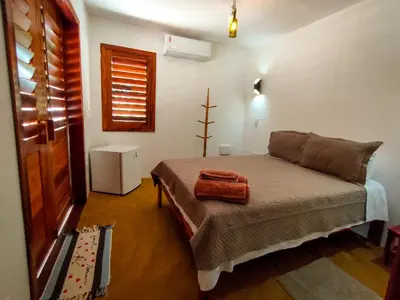 Uma cama ou camas num quarto em Icarai Kite House