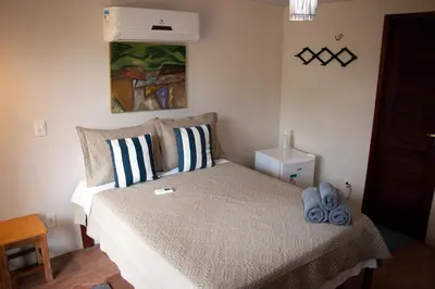 Uma cama ou camas num quarto em Icarai Kite House