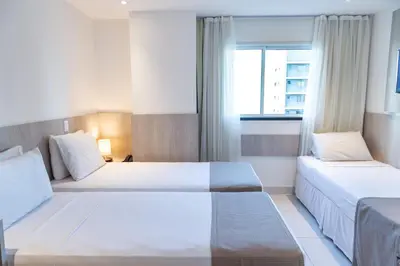 Uma cama ou camas num quarto em Aquidabã Praia Hotel