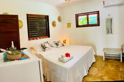 Uma cama ou camas num quarto em Pousada Tangerina
