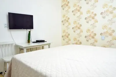 Uma televisão e/ou sistema de entretenimento em Pousada Casa da Adriana