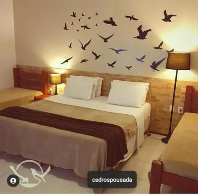 Uma cama ou camas num quarto em Cedros Pousada