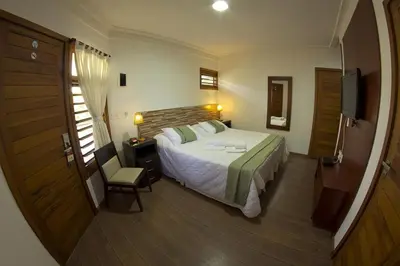 Uma cama ou camas num quarto em Hotel Vale das Nuvens