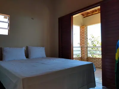 Uma cama ou camas num quarto em Chalé Sinfonia do Mar - Vista Paradisíaca