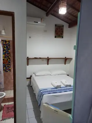 Uma cama ou camas num quarto em Pousada do farol