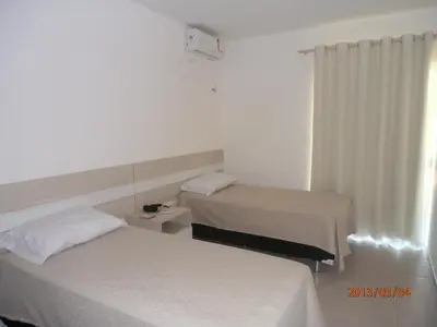 Uma cama ou camas num quarto em Apart Canoa Quebrada