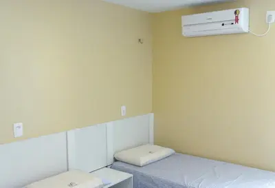 Uma cama ou camas num quarto em Pousada NS Fátima