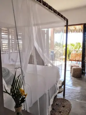 Uma cama ou camas num quarto em Villa Binn Preá
