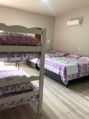 Uma cama ou camas num quarto em Pousada Caminho do Paraíso