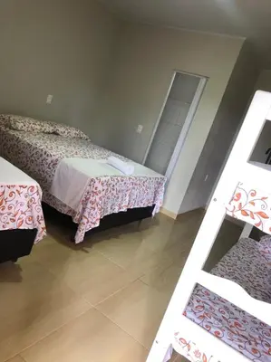 Uma cama ou camas num quarto em Pousada Caminho do Paraíso