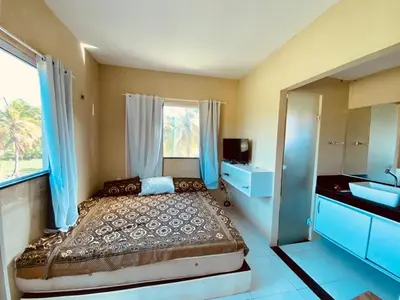 Uma cama ou camas num quarto em Casa em flecheiras com piscina