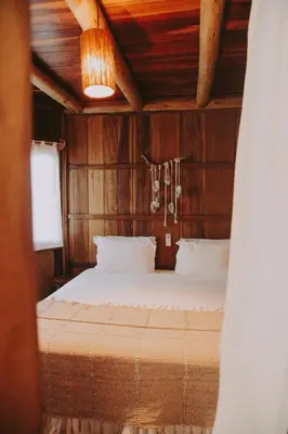 Uma cama ou camas num quarto em Pousada Jardim do vento