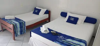 Uma cama ou camas num quarto em Hotel Arco-Íris