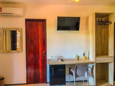 Uma televisão e/ou sistema de entretenimento em Pousada Paraíso do Vento