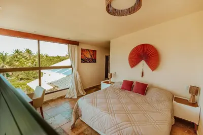 Uma cama ou camas num quarto em Vila Harmonia sua casa na Praia do Preá