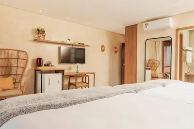 Uma cama ou camas num quarto em Pousada Kiriri