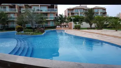 A piscina em ou perto de PALM BEACH Porto das Dunas, apartamento todo climatizado TÉRREO a 350 metros Beach Park