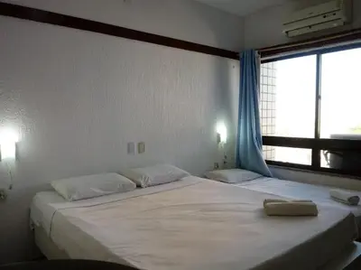 Uma cama ou camas num quarto em Tabajara Flats Praia de Iracema