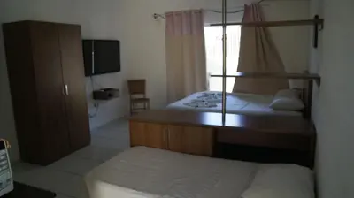 Uma cama ou camas num quarto em Pousada Brisa da Canoa