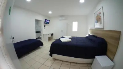 Uma cama ou camas num quarto em LIVE IN FORTALEZA HOTEL