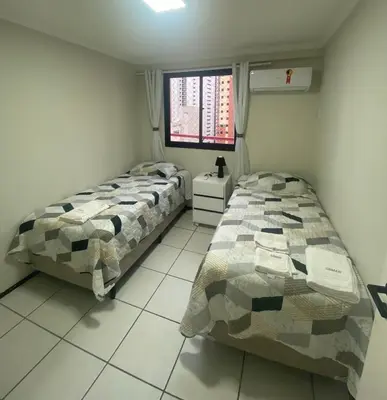 Uma cama ou camas num quarto em Ed. Porto de Iracema com Vista para o Mar