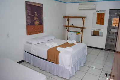 Uma cama ou camas num quarto em Pousada Numei de Jeri