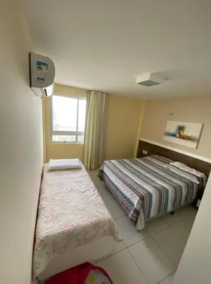Uma cama ou camas num quarto em TerraMaris Apartamento Beira Mar Pé na areia