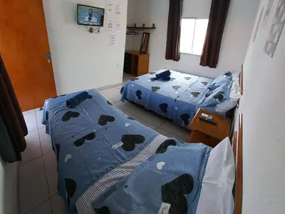 Uma cama ou camas num quarto em Hospedaria da Praia Fortaleza