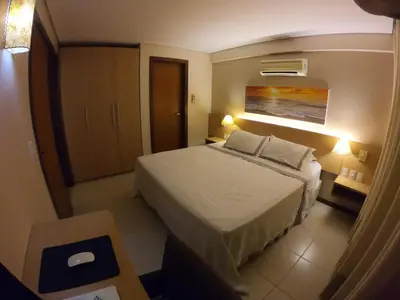 Uma cama ou camas num quarto em [Kariri 215] 46m², pé na areia, varanda vista mar!