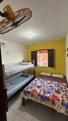 Uma cama ou camas num quarto em Residência Tatiane canoa