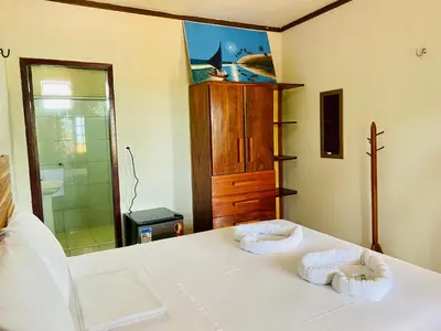 Uma cama ou camas num quarto em Pousada Carmela
