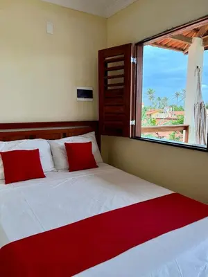 Uma cama ou camas num quarto em Suíte das flores em Guajiru